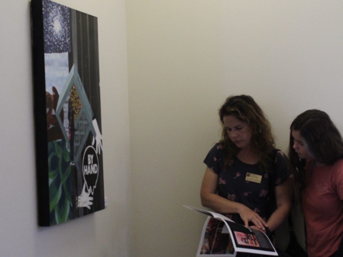 Dr. Miller-Tomlinson looking at a flyer