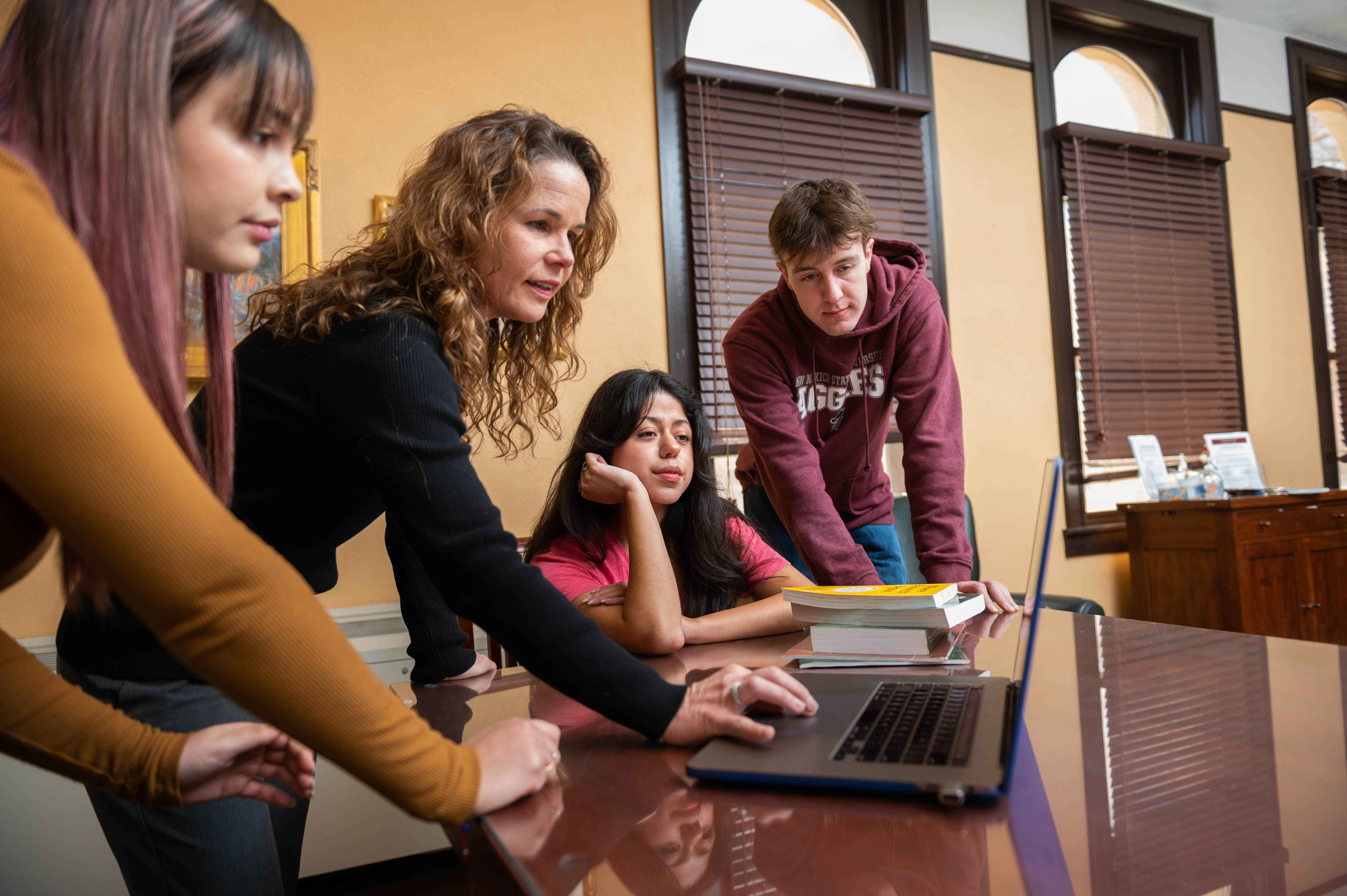 students working in honors college around a computer